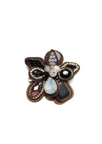 Intricate handmade butterfly brooch featuring black, white, and iridescent gemstones, perfect for unique jewelry and accessory collections.