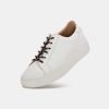White leather chunky sole sneakers with black and red laces, stylish and comfortable casual footwear, perfect for everyday wear and modern fashion statements.