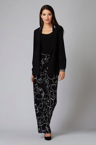 Elegant business casual woman wearing a tailored black blazer and stylish abstract face pattern pants for modern professional looks.