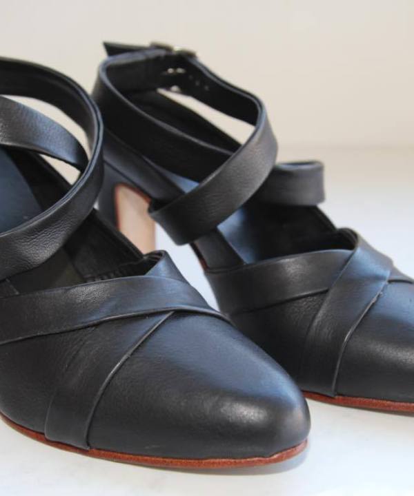 Black leather high-heeled shoes with ankle straps, stylish and elegant footwear for women, ideal for fashion-forward outfits and special occasions.