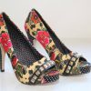 Vibrant floral high heels with studded accents and polka dot interior, perfect for fashion-forward women and special occasions.