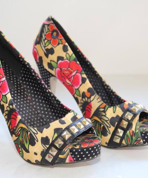 Vibrant floral high heels with studded accents and polka dot interior, perfect for fashion-forward women and special occasions.