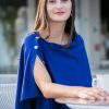 Elegant woman in a royal blue dress sitting outdoors, showcasing stylish fashion for women, modern casual wear, and sophisticated summer outfit ideas for women.