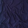 Luxury navy blue velvet fabric with soft drapes and folds, high-quality textile for apparel and home decor, elegant and smooth velvet material for fashion and interior design.