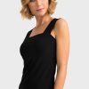 Elegant woman in black sleeveless top and maroon pants on white background, showcasing stylish and comfortable fashion look, perfect for casual or professional settings, by Katyamaker.