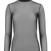 Bold black turtleneck top with sheer, fitted long sleeves, perfect for layered fall or winter fashion statements.