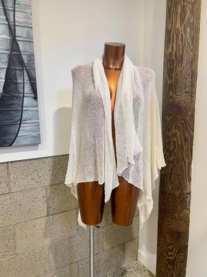 Elegant, lightweight women's shawl or wrap showcased on a mannequin, perfect for layering and adding a touch of sophistication to any outfit, ideal for spring or fall fashion.