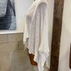 Soft cream cashmere shawl draped over mannequin, lightweight and elegant perfect for versatile layering and stylish accessories.