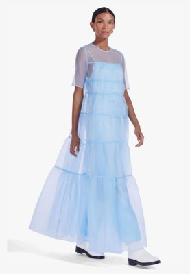 Blue layered mesh maxi dress with sheer short sleeves and tiered design, styled with black and white boots, perfect for fashion-forward spring or summer outings.