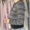 Black and white plaid blazer with tailored fit, front pockets, and sleek design, perfect for stylish office wear or casual outings.