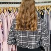 Cute woman shopping for trendy clothes, browsing jackets in a clothing store, fashion, winter outerwear, shopping experience, casual style, retail fashion, shopper in store, modern wardrobe selection, apparel shopping, stylish outfits, women’s fashion.