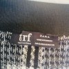 Black and white checkered skirt tag details, showcasing Zara TRF collection label and size 28, made in Romania, with high-quality knitted fabric, ideal for stylish casual wear.