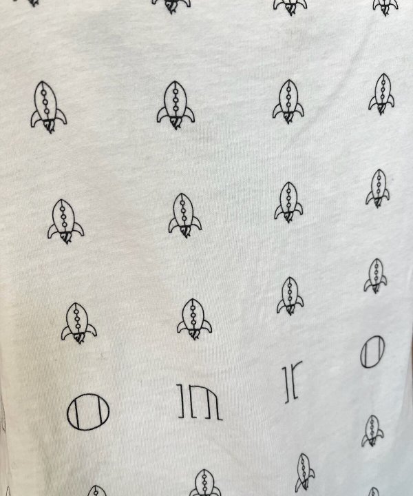 Rocket pattern fabric with minimalist black line drawings of rockets for custom sewing projects and crafts.