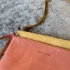 Elegant leather clutch and wristlet set featuring Pierre Cardin embossed design, perfect for stylish accessories and date night outfits.