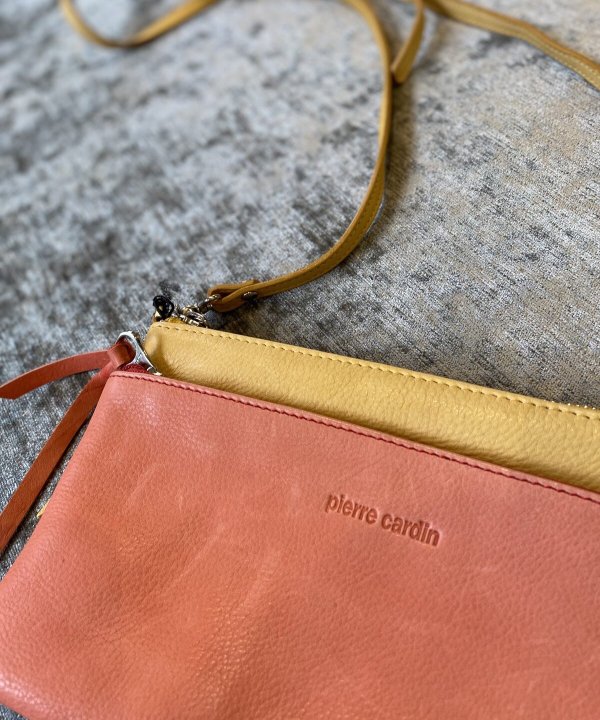 Elegant leather clutch and wristlet set featuring Pierre Cardin embossed design, perfect for stylish accessories and date night outfits.