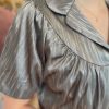 Shiny metallic blouse with puff sleeves and a collar, featuring elegant, pleated fabric detail for stylish women’s fashion. Perfect for chic, trendy outfits and special occasions.