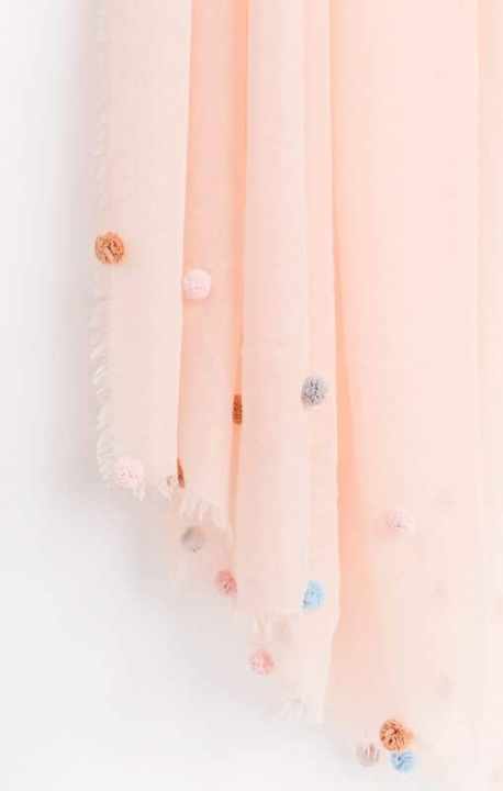 Pink and cream tassel and pom-pom throw blanket, cozy home decor, handmade soft textile, decorative accessory for living room, stylish and vibrant interior piece.