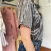 Shiny metallic short-sleeve top with shoulder detail, stylish fashion clothing for women, perfect for trendy casual outfits.