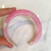 Pink marbled resin cuff bracelet, handmade jewelry accessory, feminine and stylish boho chic statement piece. Perfect for layered look or standalone accent, lightweight and comfortable to wear.