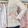 Beige plaid blazer on a female mannequin, tailored with a textured pattern, stylish and sophisticated for women’s fashion.