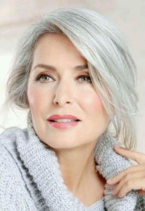 Elegant senior woman with stylish gray hair, natural makeup, and cozy knit sweater, representing beauty, confidence, and aging gracefully for a portrait of mature women.