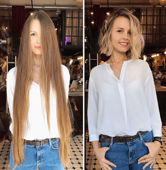 Long, straight, blonde hair with a natural look, wearing a white blouse and jeans, in an indoor setting with warm lighting.