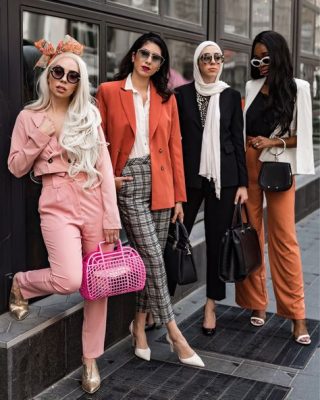 Stylish diverse women in trendy outfits and accessories standing outdoors in an urban setting, showcasing fashion-forward streetwear and chic handbags.