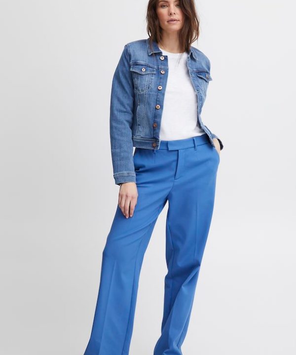 Bright blue tailored high-waisted trousers with a relaxed fit, paired with a casual white t-shirt and classic denim jacket for a stylish, versatile look.
