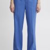 Wide-leg blue tailored trousers with high waist, front pleats, and belt loops, perfect for professional and casual outfits. Made from high-quality fabric for a comfortable fit.