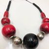 Colorful statement necklace with large red, black, and metallic beads, handcrafted jewelry design, bold accessories for women, perfect for casual or special occasions.