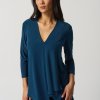 Flowy blue V-neck women's blouse with layered hem, stylish and comfortable for office or casual wear, designed by katyamaker for modern fashion.