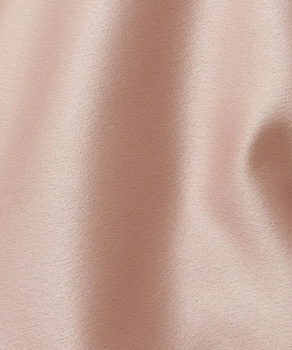 Silky rose gold satin fabric texture, luxurious material for fashion and interior design, smooth draping and elegant appearance.