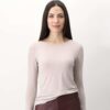 Soft beige long-sleeve casual top worn by a woman with dark hair, minimal makeup, and subtle smile, showcasing comfortable and stylish everyday fashion.
