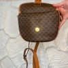 Vintage designer handbag with monogram print and leather accents for women, showcasing luxury and style.