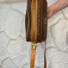 Brown designer handbag with monogram pattern, gold zipper, and leather accents, stylish accessory for everyday and travel.