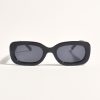 Black fashion sunglasses with dark lenses on a white background.