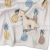 Soft pastel-colored baby blanket featuring a cute plush giraffe toy and pineapple print for nursery decor and baby gift ideas.