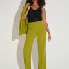Elegant woman's fashion look featuring a lime green blazer and matching wide-leg pants paired with a black sparkly sleeveless top, stylish heels, and confident pose, showcasing modern professional and evening wear.