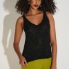 Shimmery black sleeveless top with a scoop neckline styled with lime green pants, showcasing modern women's fashion and accessories.