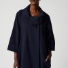 Elegant navy blue designer coat with a draped collar, perfect for stylish winter or fall outfits. Features a relaxed fit and sophisticated silhouette, ideal for modern, minimalist fashion.