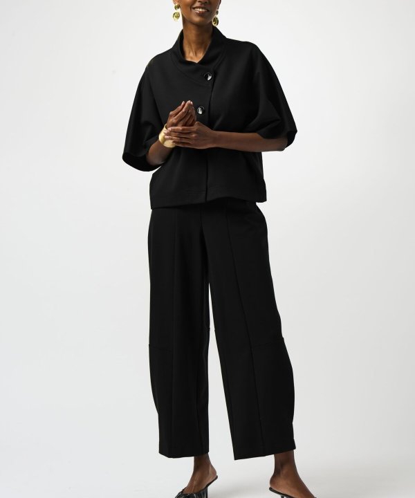 Black modern women's fashion outfit featuring a stylish black top and wide-leg trousers, accessorized with gold jewelry, showcasing elegant and versatile dressing for sophisticated occasions.