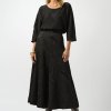 Black textured midi skirt and matching top with abstract pattern, stylish and elegant fashion outfit for women. Perfect for chic, modern, and sophisticated looks in fall and winter seasons.