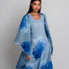 Flowy blue and white abstract-patterned dress and matching cape, modern fashion look from Katya Maker collection emphasizing artistic prints and elegant design.