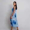 Flowy blue and white tie-dye maxi dress with pleats, perfect for summer and casual wear, styled with black sandals.
