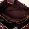 Luxurious designer handbag interior featuring high-quality fabric lining with iconic Louis Vuitton monogram pattern and gold hardware details.