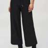 Comfy black wide-leg pants with a starry sparkle pattern, perfect for casual or elegant outfits, featuring an elastic waistband with a drawstring for adjustable fit.