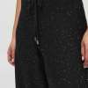 Sparkly black jogger pants with a drawstring waist and silver glitter accents, perfect for casual and stylish wear.