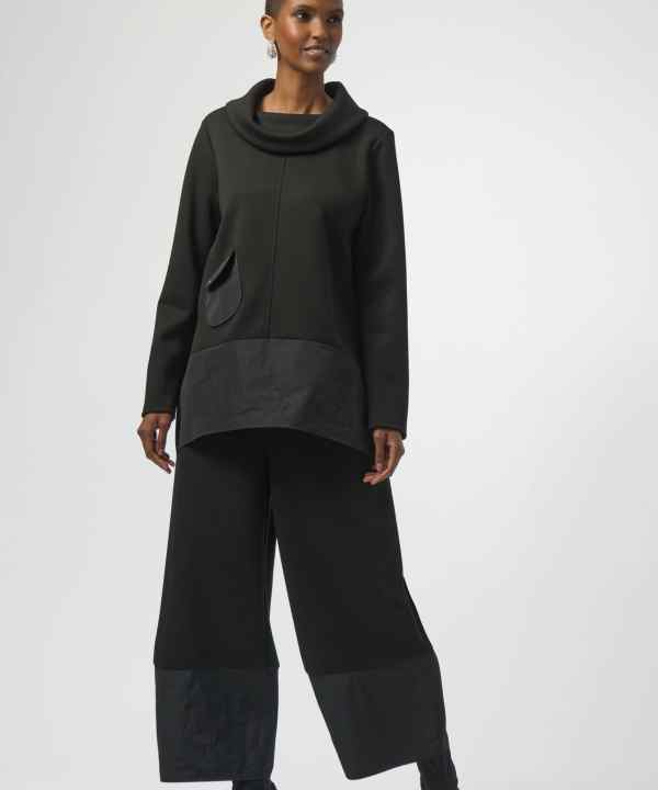Elegant black fashion outfit featuring a modern oversized top with a cowl neckline and wide-leg pants, perfect for contemporary style and versatile for various occasions.