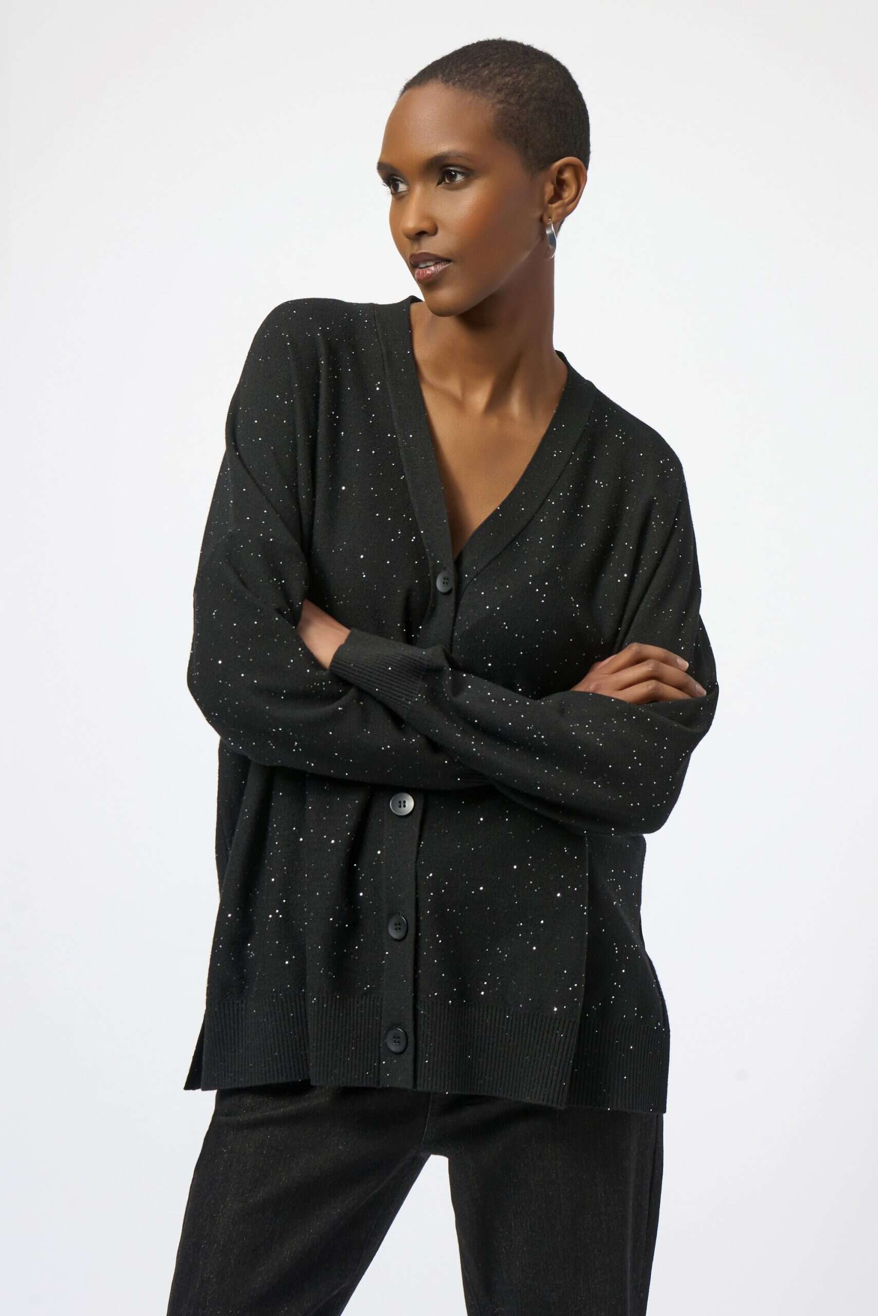 Luxurious black cardigan with subtle glitter accents, perfect for cozy winter fashion and casual elegance.