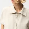 Elegant beige zip-up jacket with classic collar, stylish and versatile for modern fashion looks, perfect for casual or elevated outfits.